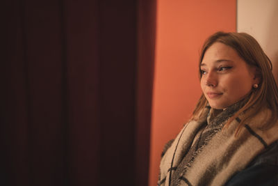 Fashionable young woman in city at night