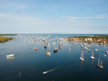 High angle view of boats on sea shore against sky