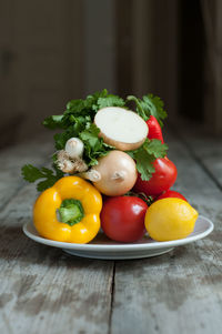 Close-up of fruits in plate on wooden table