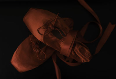 Close-up of ballet shoes against black background