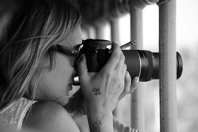 Close-up portrait of woman photographing