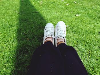 Low section of woman on field