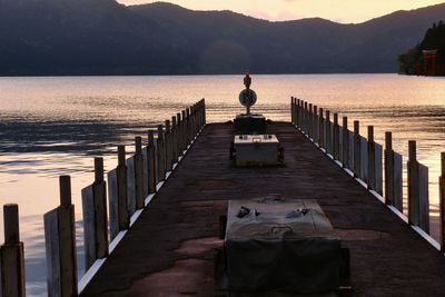 Rear view of man on pier over sea against sky