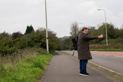 Man gesturing while standing on road