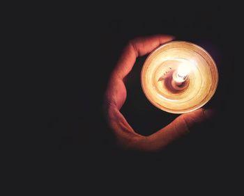 Close-up of hand holding illuminated lamp