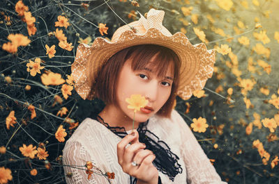 Portrait of cute girl holding flowers