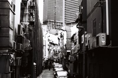 Narrow street amidst buildings in city