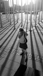 Rear view of girl standing on floor