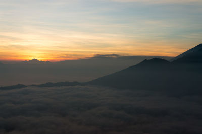 Scenic view of mountains against cloudy sky