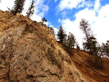 Low angle view of rock formation against sky