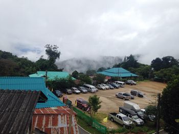 High angle view of houses and trees against sky