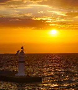 Scenic view of sea against orange sky