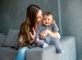 Happy mother with baby at home
