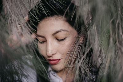 Close-up portrait of young woman with eyes closed