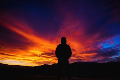 Silhouette of man against sky at night