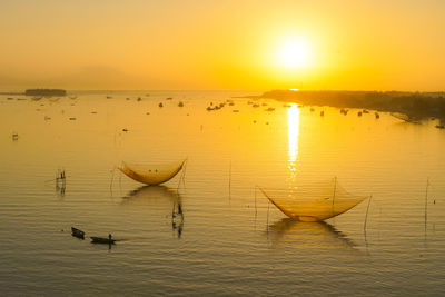 Scenic view of lake against sky during sunset