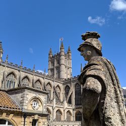 Low angle view of statues on building against sky