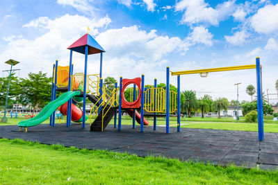 Rear view of woman swinging at playground