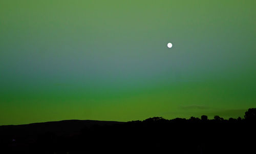 Scenic view of silhouette landscape against sky at night