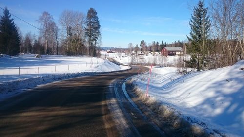 Road passing through snow covered landscape