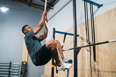 Full length of man exercising in gym