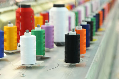 Close-up of multi colored bottles on table