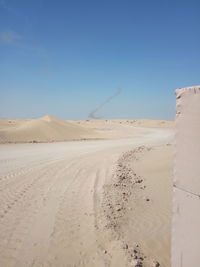 Scenic view of desert against clear blue sky