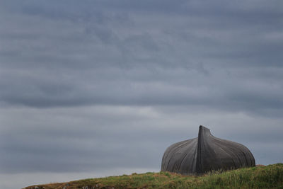 Built structure on field against sky