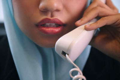 Cropped image of businesswoman talking on phone in office