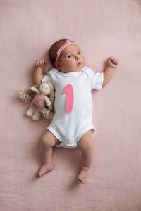 Portrait of cute baby boy playing with teddy bear