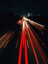 High angle view of light trails on highway at night