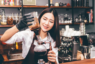 Portrait of a smiling young woman in restaurant