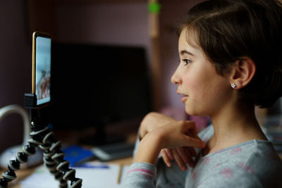 Side view of girl on video call