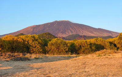 Scenic view of mountains against clear blue sky