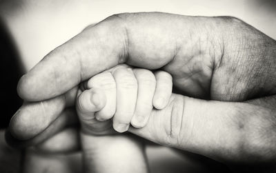 Close-up of baby holding hands