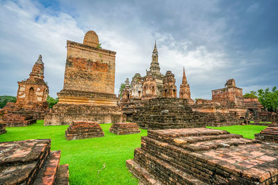 Old temple building against cloudy sky