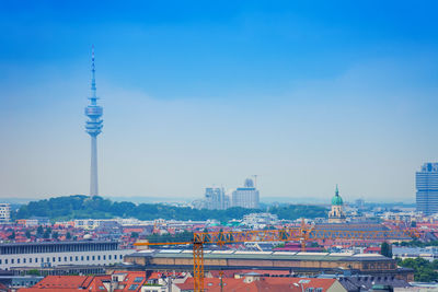 Tower amidst buildings in city against sky