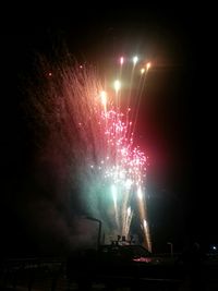 Low angle view of firework display at night