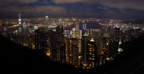 Illuminated cityscape against sky at night