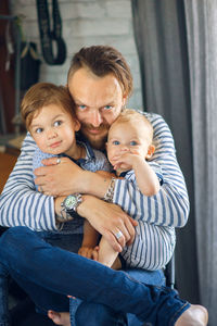 Portrait of father and kits at home