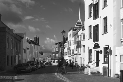 Vehicles on road along buildings