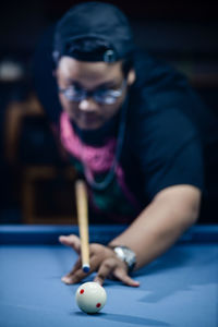 Close-up of man playing pool