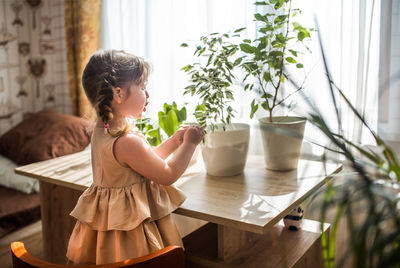 Woman sitting on table at home