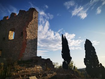 Low angle view of old building against sky, sunset in toscana