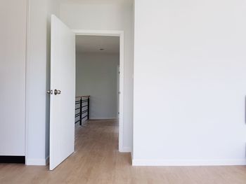 A room with door open. white wall