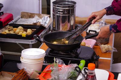 A mother is preparing food at the pempek snack festival