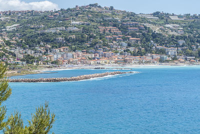 Aerial view of city by sea