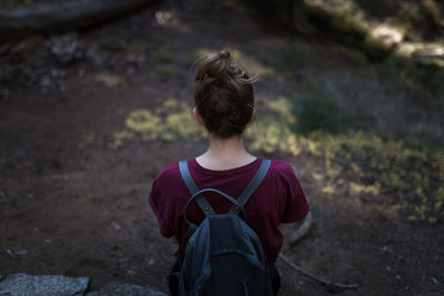 High angle view of woman with backpack on field