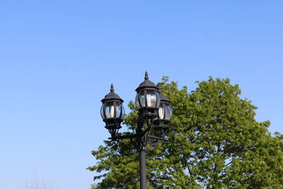 Low angle view of street light against clear blue sky