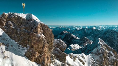 Panoramic view of mountains against clear sky during winter